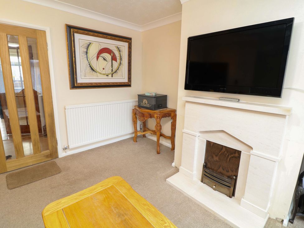 A living room with a television and fireplace at 5 Overstone Drive Wisbech