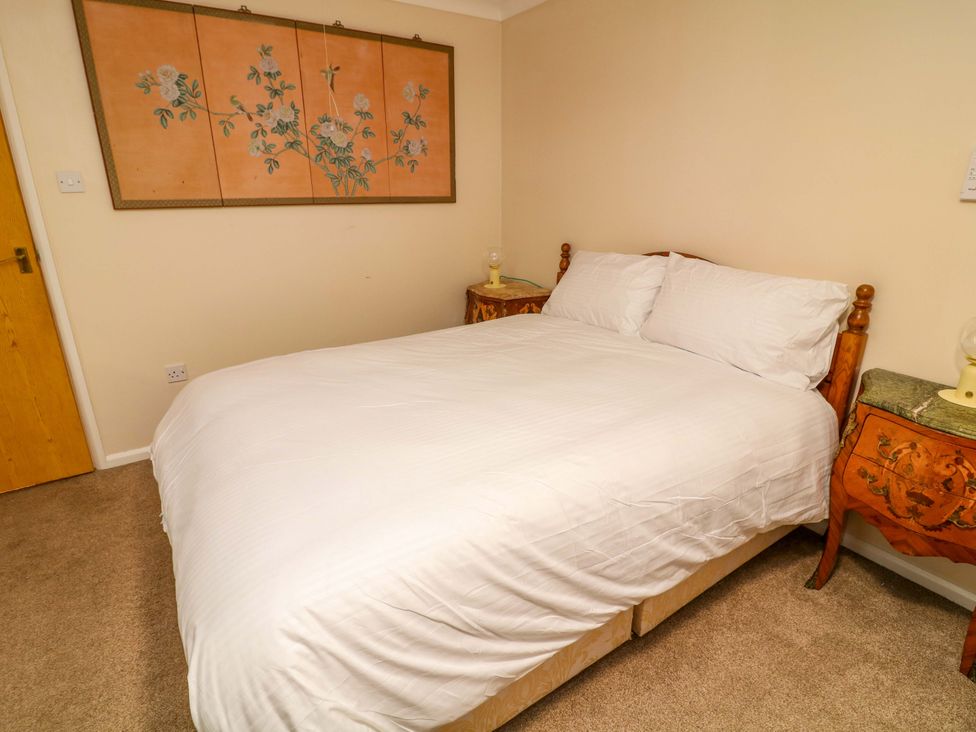 A bedroom with a bed and bedside tables at 5 Overstone Drive, Wisbech