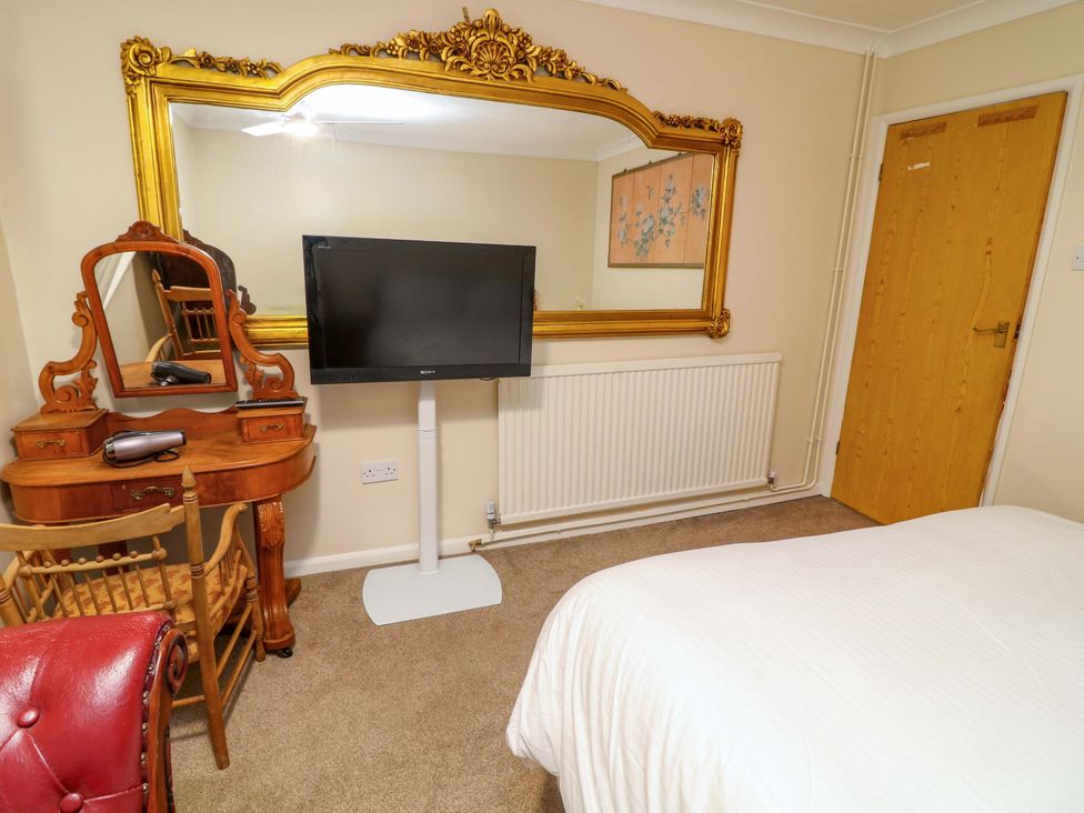 A bedroom with a bed and a television at 5 Overstone Drive, Wisbech
