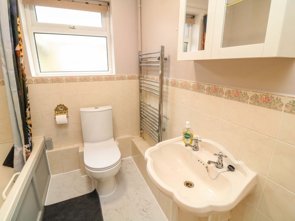 A bathroom with a toilet and sink at 5 Overstone Drive Wisbech