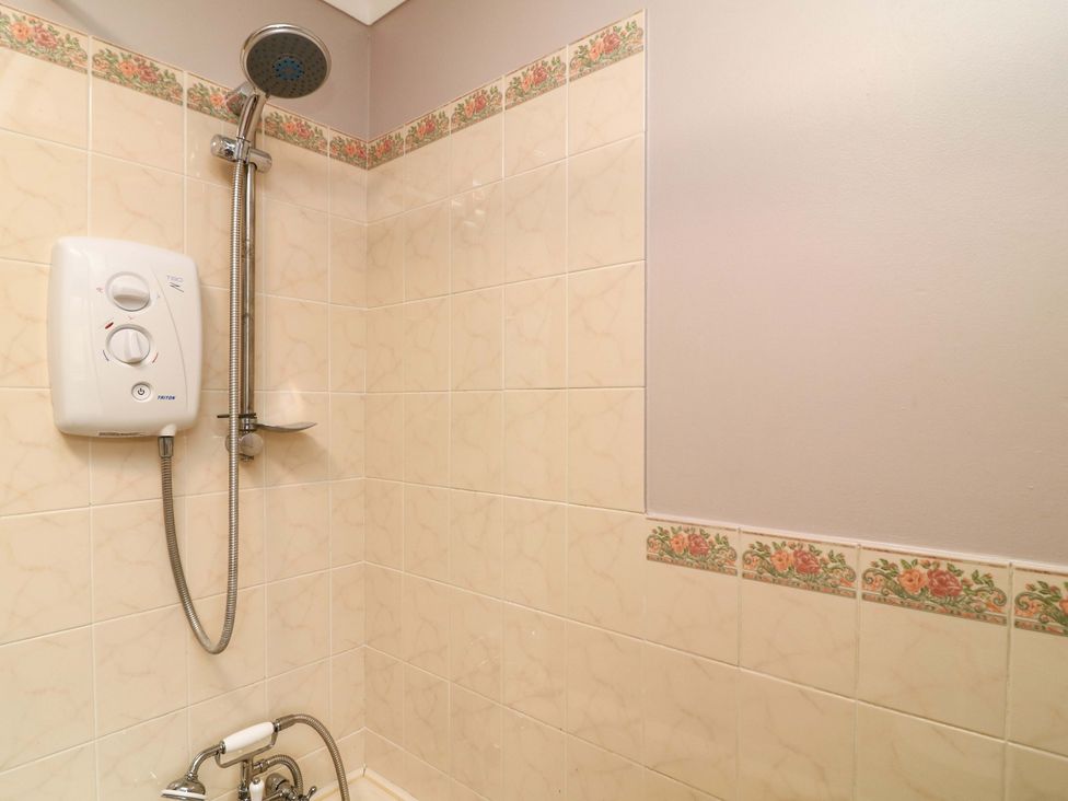 A shower with shower head and control panel at 5 Overstone Drive Wisbech