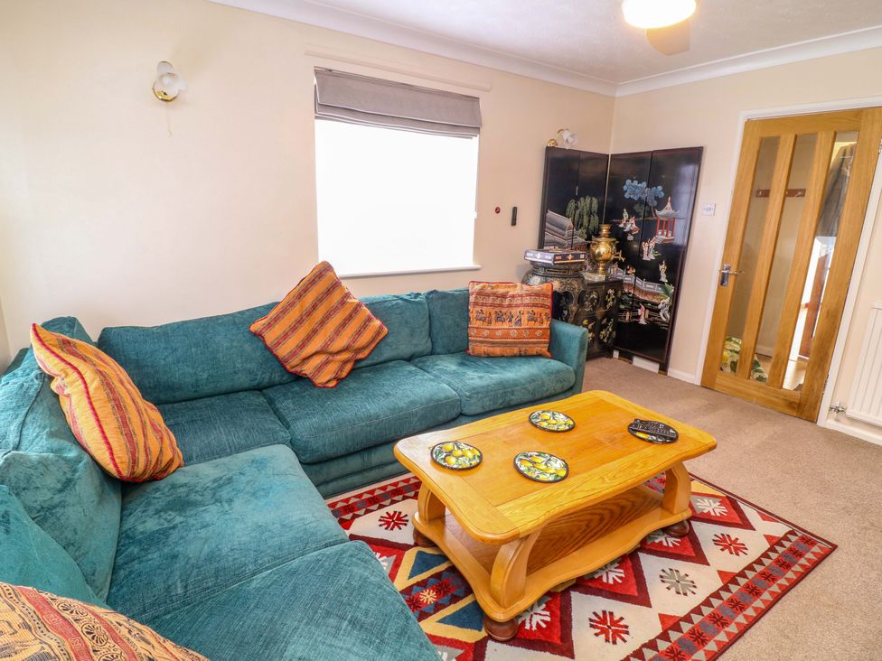 A living room with a couch and coffee table at 5 Overstone Drive in Wisbech