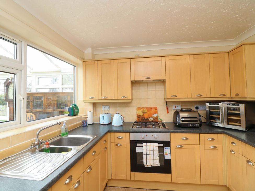 A kitchen with cabinets and appliances at 5 Overstone Drive in Wisbech