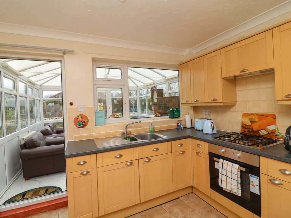 A kitchen with cabinets and a gas stove at 5 Overstone Drive Wisbech
