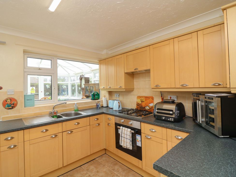 A kitchen with cabinets and appliances at 5 Overstone Drive Wisbech
