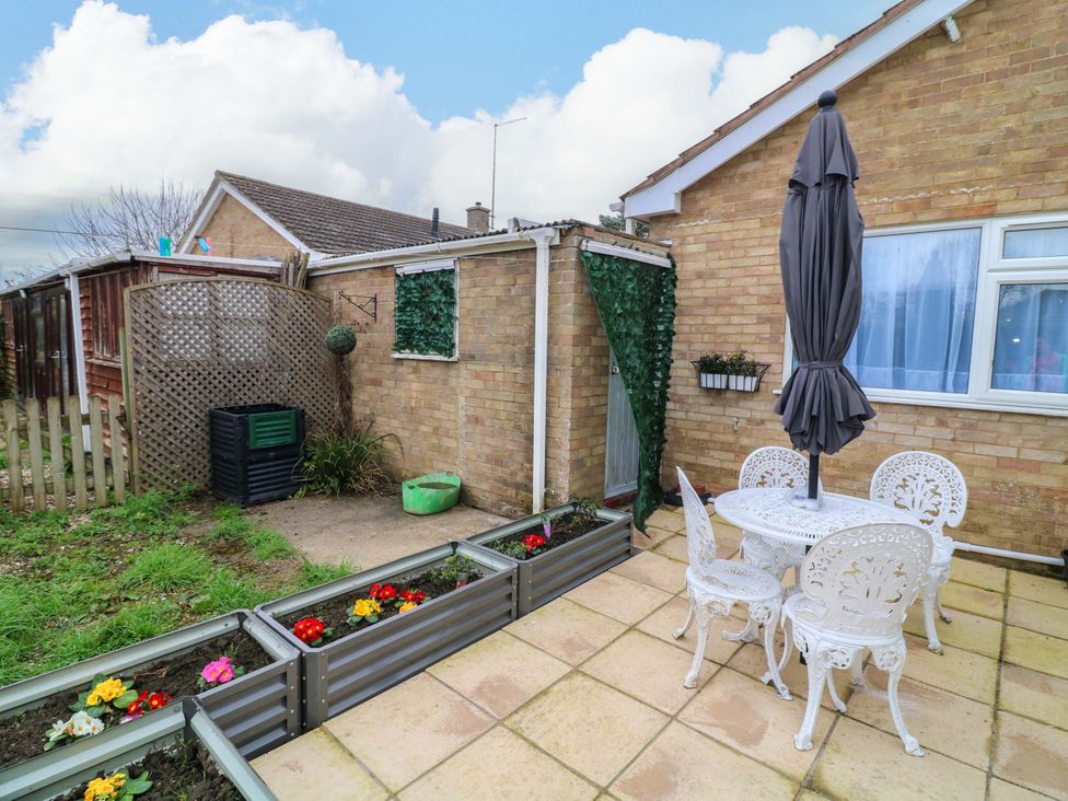 A garden with a table and chairs at 5 Overstone Drive in Wisbech