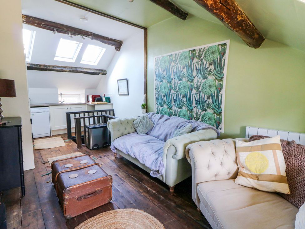 A living room with a kitchenette and skylight at The Little Laura Ashley House in Machynlleth