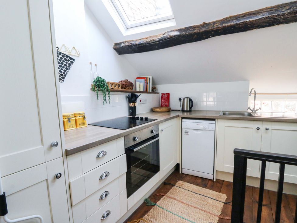 A kitchen with appliances and a window at The Little Laura Ashley House Machynlleth