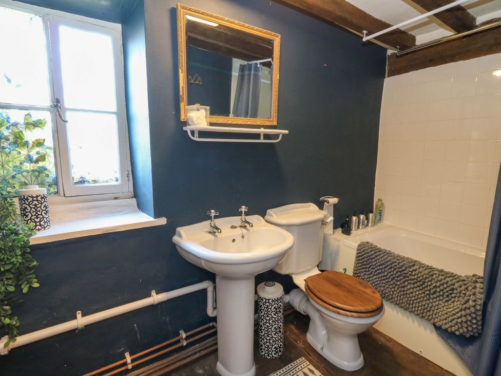 A bathroom with a sink, toilet, and bathtub at The Little Laura Ashley House Machynlleth
