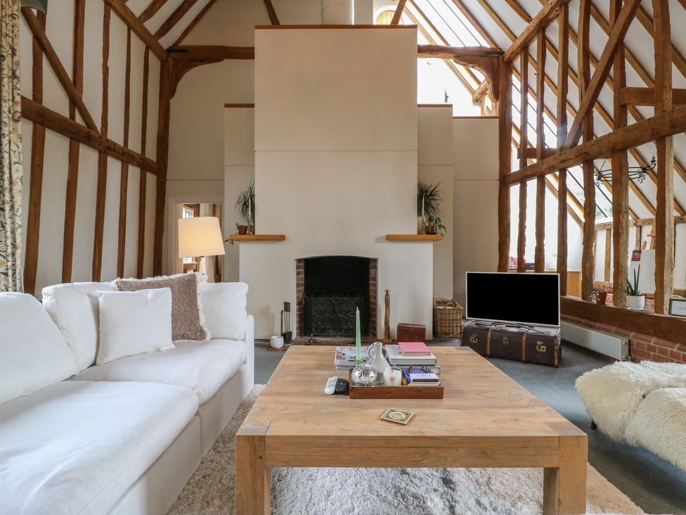 A living room with a sofa and coffee table at Headland Barn in Maldon
