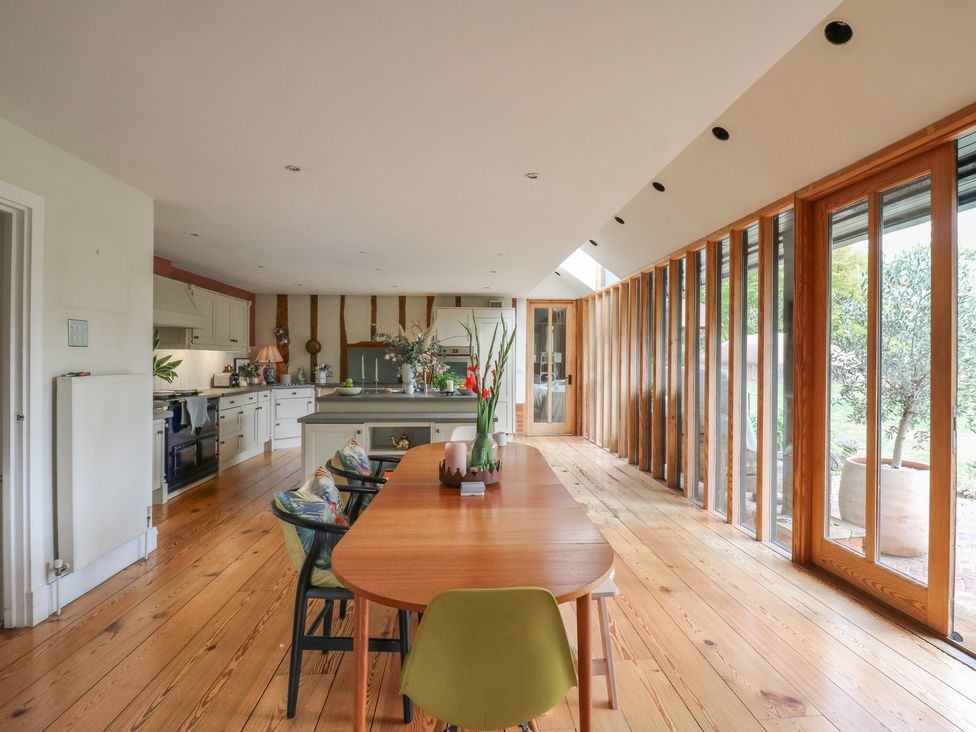 A kitchen with a dining table and chairs at Headland Barn in Maldon