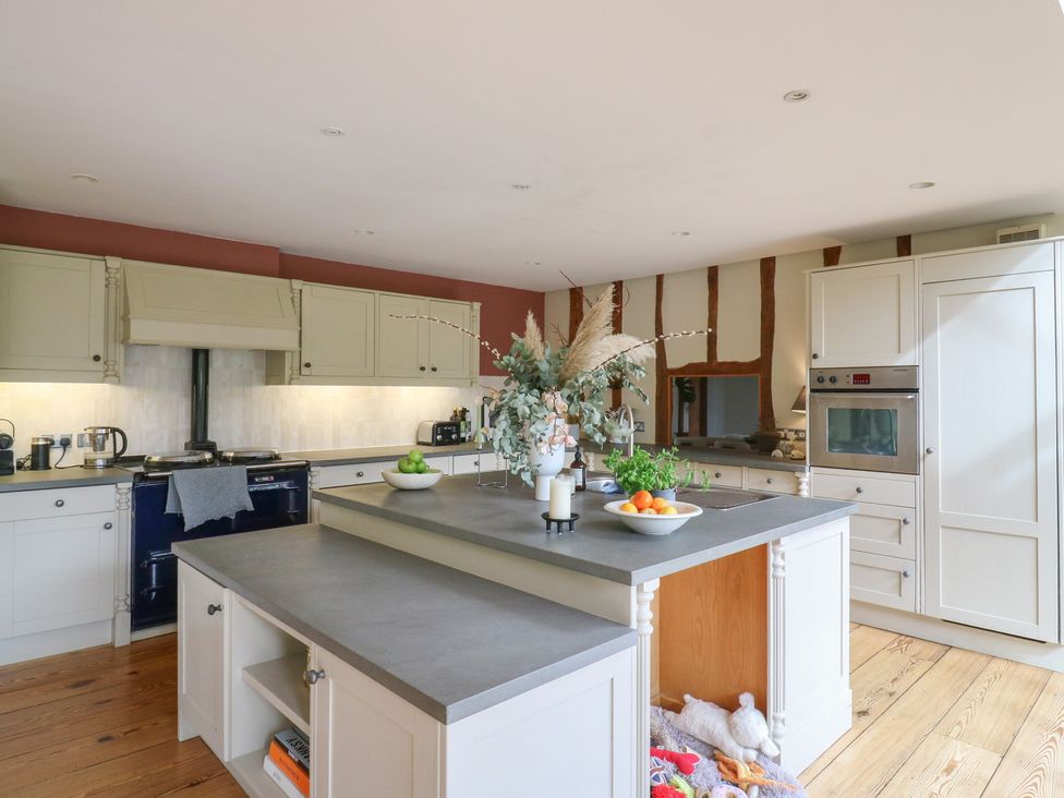 A kitchen with an island and various appliances at Headland Barn in Maldon