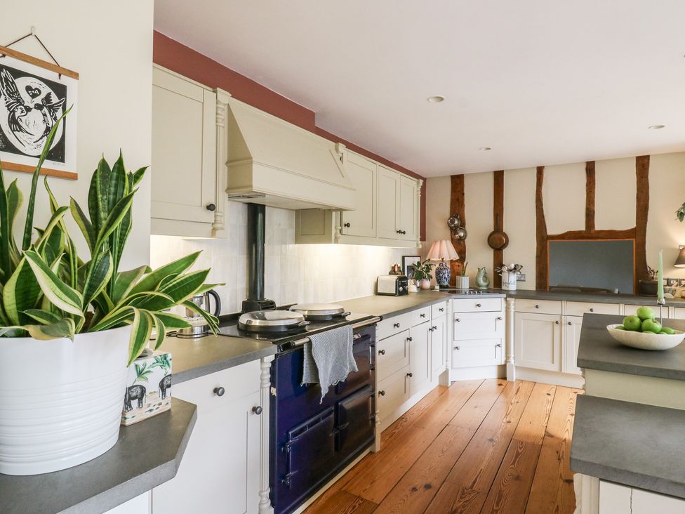 A kitchen with cabinets and a stove at Headland Barn in Maldon