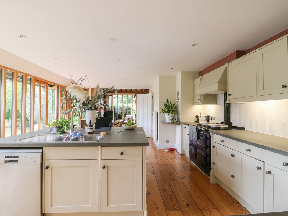 A kitchen with modern appliances and plants at Headland Barn in Maldon