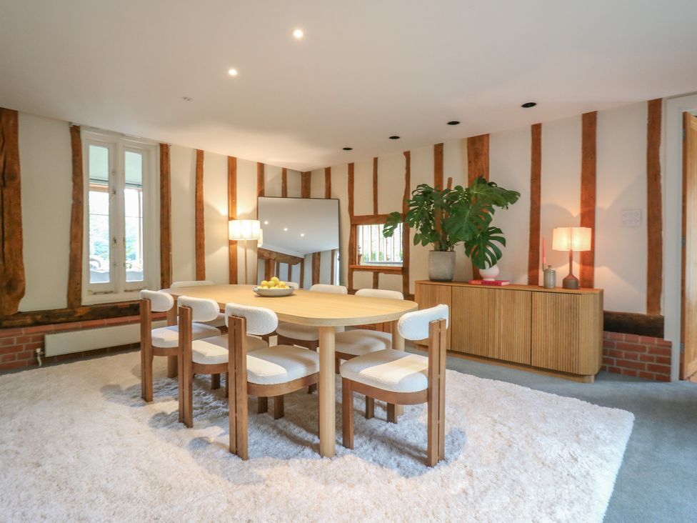 A dining room with a table and chairs at Headland Barn, Maldon