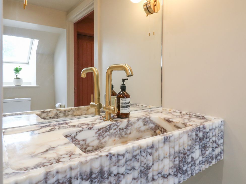 A bathroom with a sink and faucet at Headland Barn in Maldon