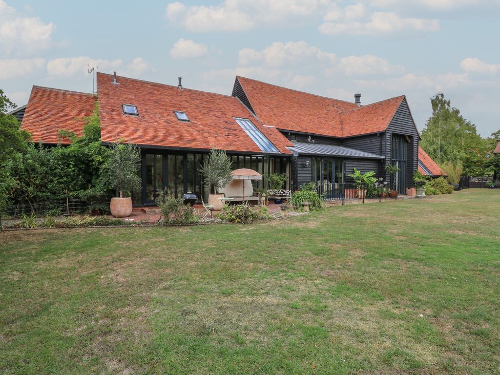 A house with a garden and patio at Headland Barn in Maldon