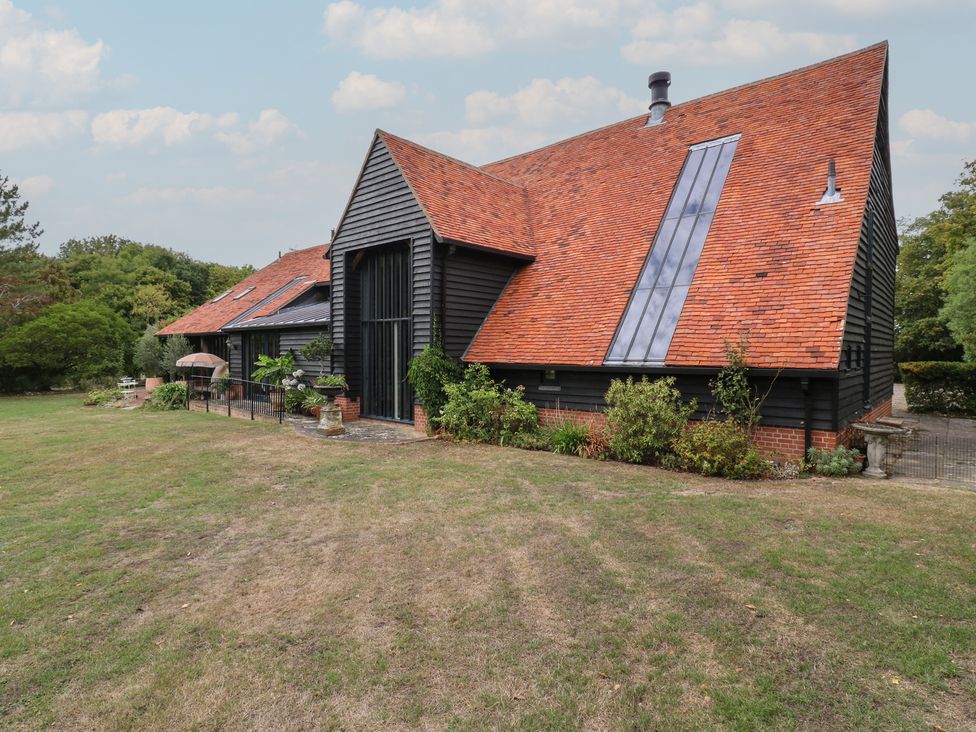 An exterior view of a house with a garden at Headland Barn in Maldon
