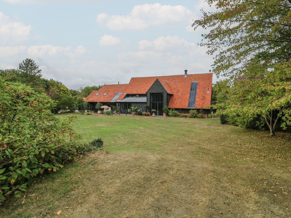 A house with a garden and trees at Headland Barn in Maldon