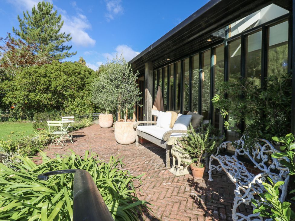 An outdoor area with a sofa and coffee table at Headland Barn in Maldon