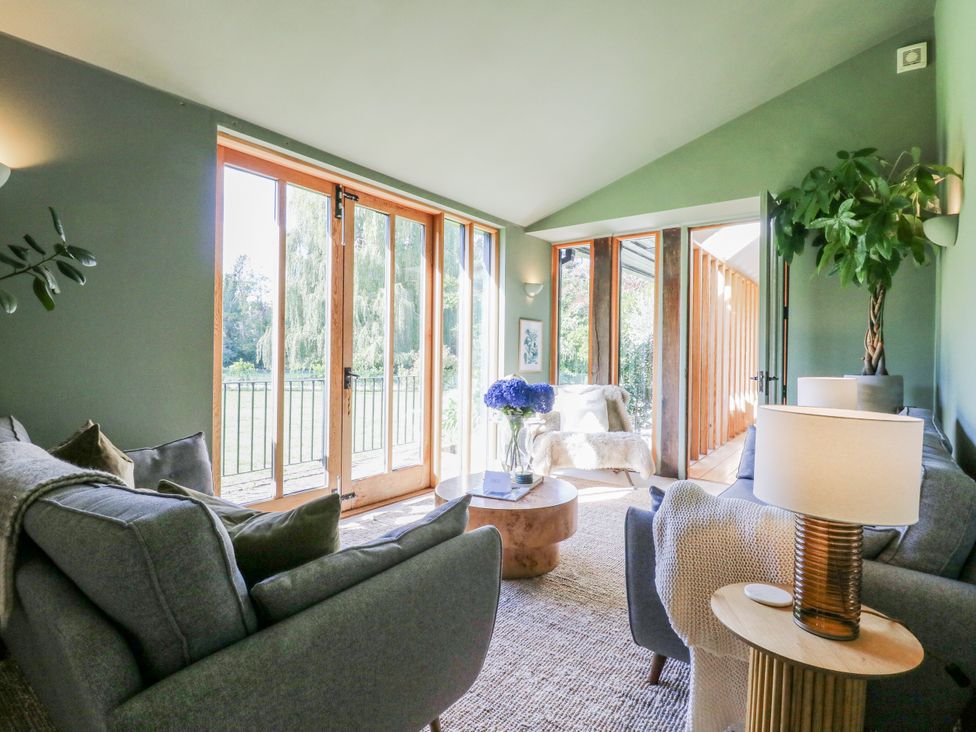 A living room with a sofa and coffee table at Headland Barn, Maldon