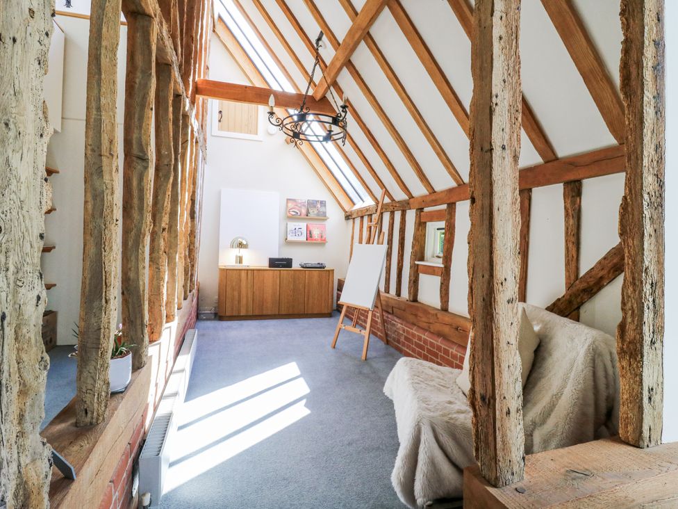 A living room with a sofa and desk at Headland Barn in Maldon