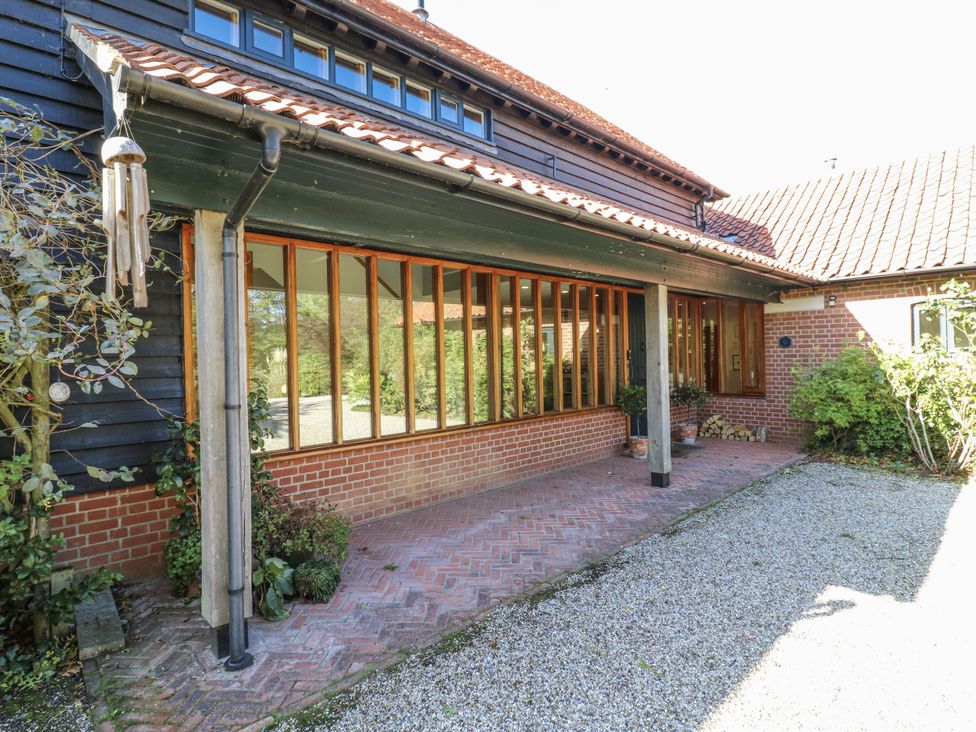 An outdoor entrance with brick and wooden structure at Headland Barn in Maldon