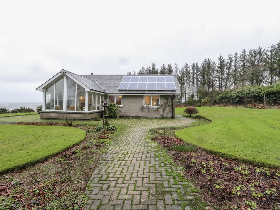 A house with solar panels and a pathway in the garden at Carnmhor in Aberdeen