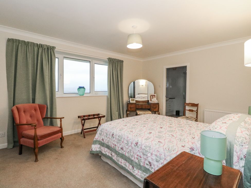 A bedroom with a bed and curtains at Carnmhor in Aberdeen
