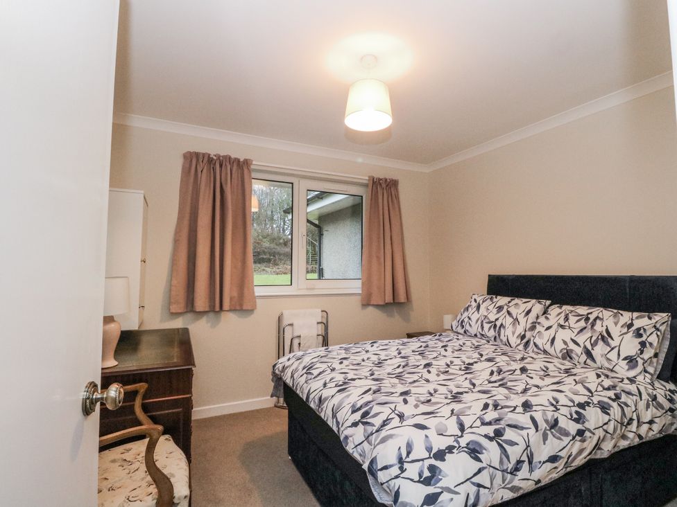 A bedroom with a bed and a window at Carnmhor in Aberdeen
