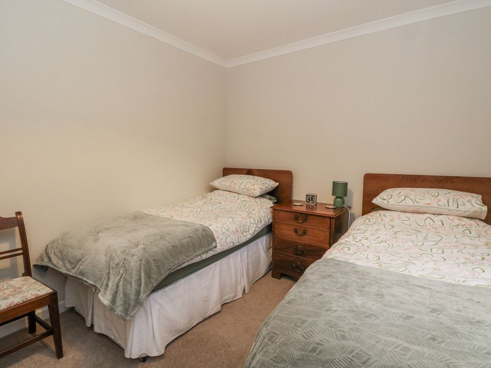 A bedroom with two beds and a nightstand at Carnmhor, Aberdeen