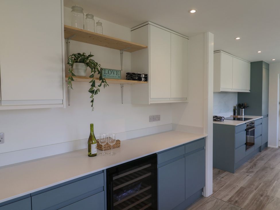 A kitchen with cabinets and a wine cooler at Oakwood in Chideock