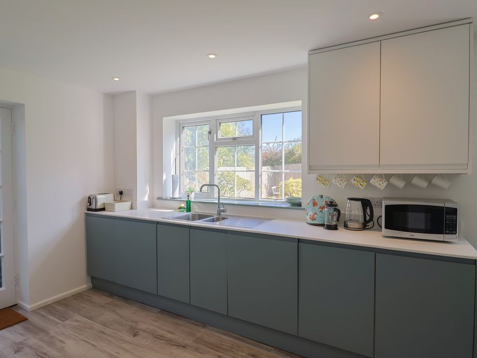 A kitchen with a sink and appliances at Oakwood in Chideock