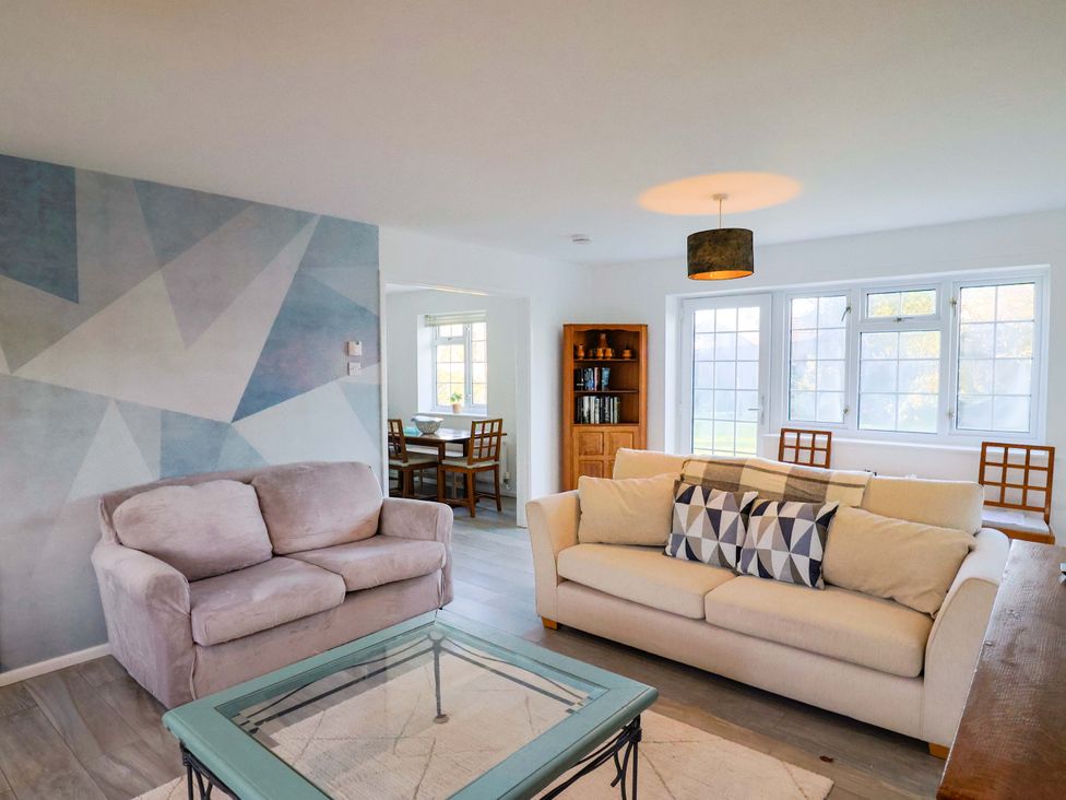 A living room with a sofa and coffee table at Oakwood in Chideock