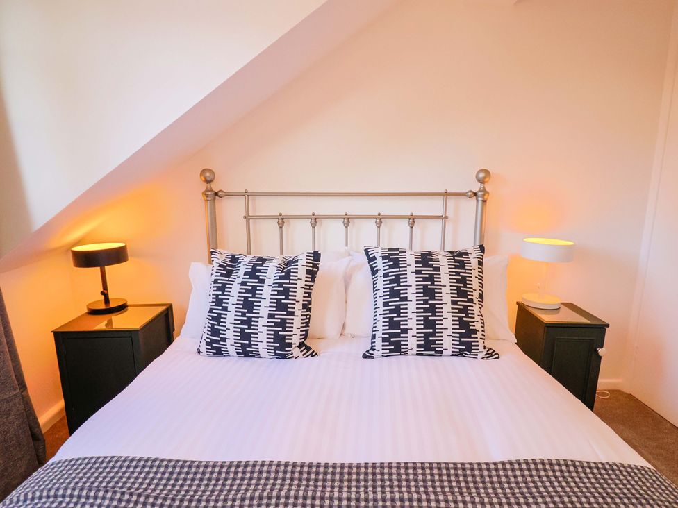 A bedroom with a bed and bedside tables at Oakwood in Chideock