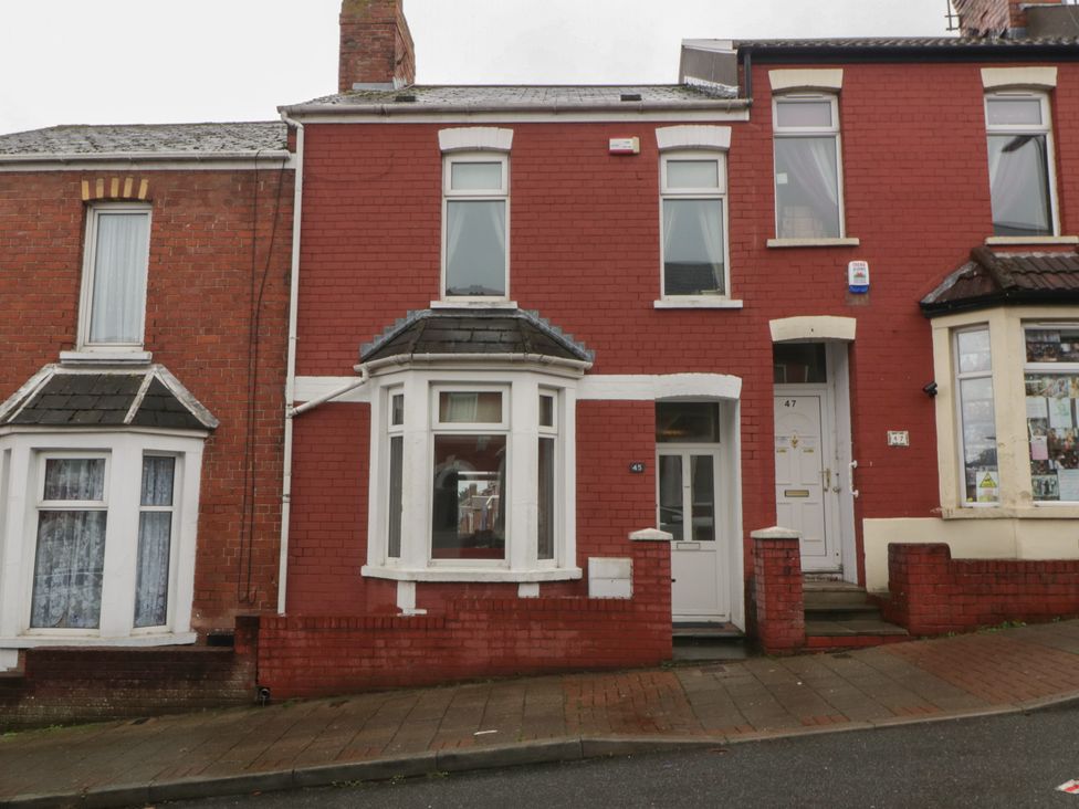 A red house with windows and door at Gavin and Stacey House in Barry