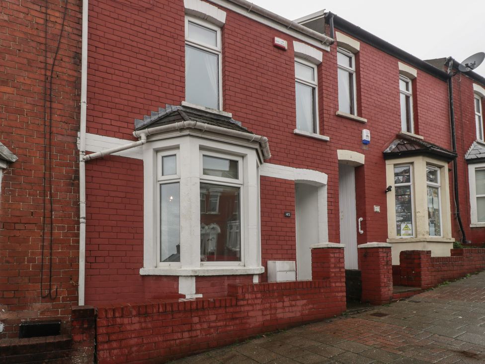 A red brick house exterior with multiple windows at Gavin and Stacey House in Barry
