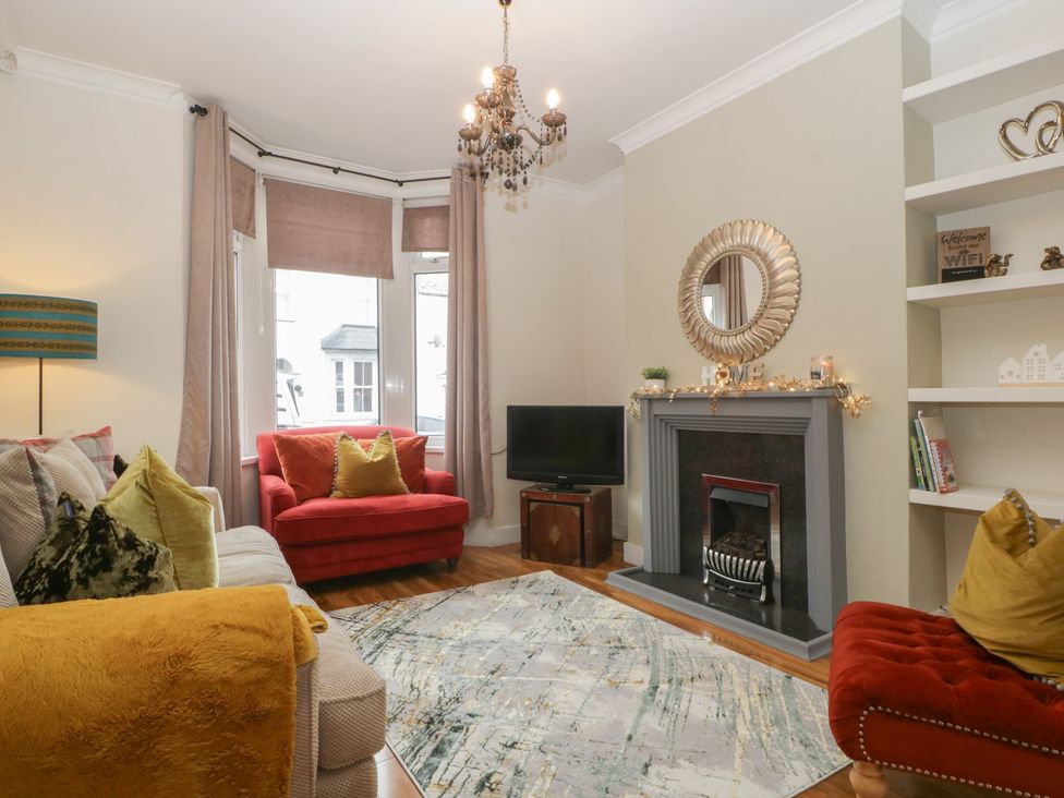 A living room with a sofa and armchairs at Gavin and Stacey House in Barry