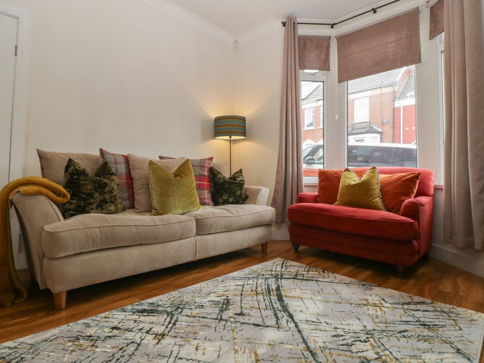A living room with a sofa and armchair at Gavin and Stacey House in Barry