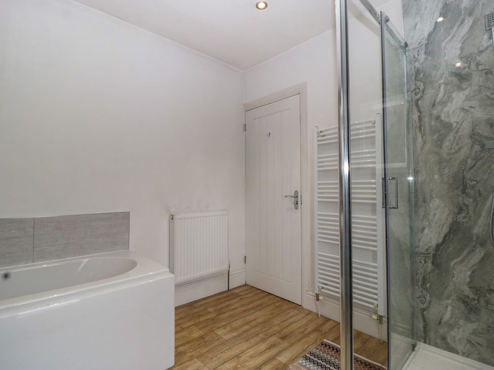 A bathroom with a bathtub and shower at Gavin and Stacey House in Barry