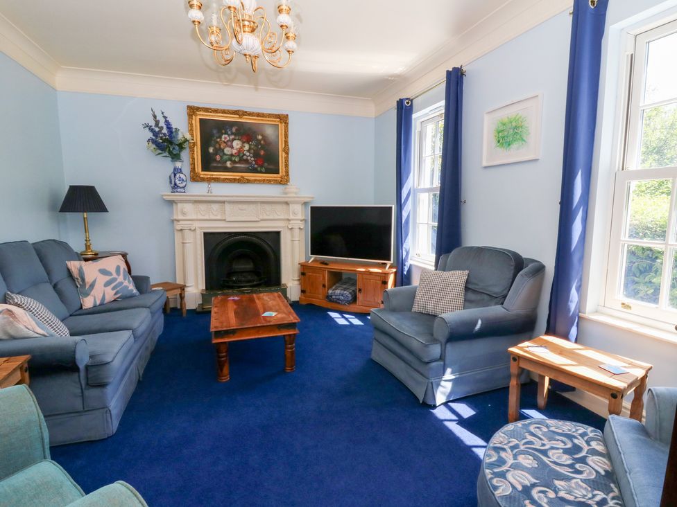 A living room with sofa and television at Ty Caredig in Swansea