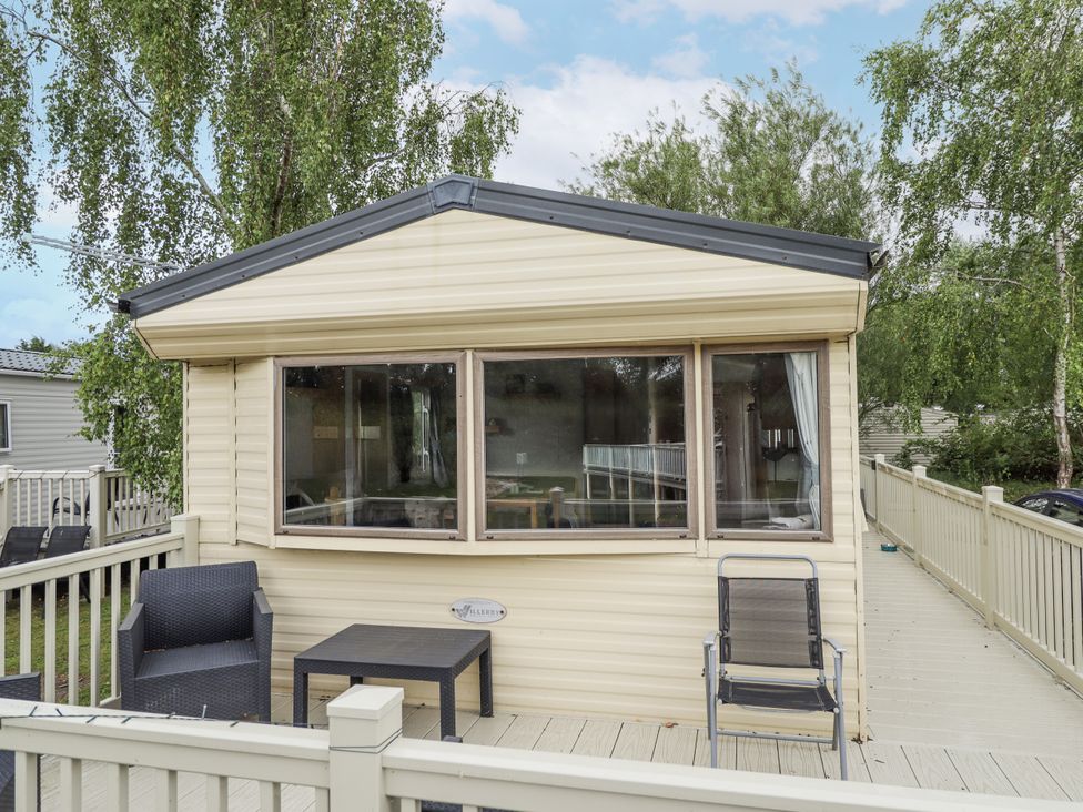 An outdoor view of a house with a deck and seating at 31 Castle View in Lincoln