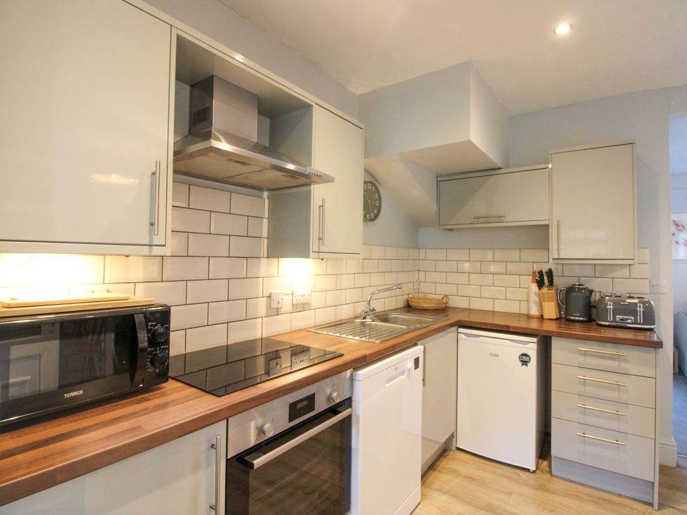 A kitchen with cabinets and appliances at Rockside in Salcombe