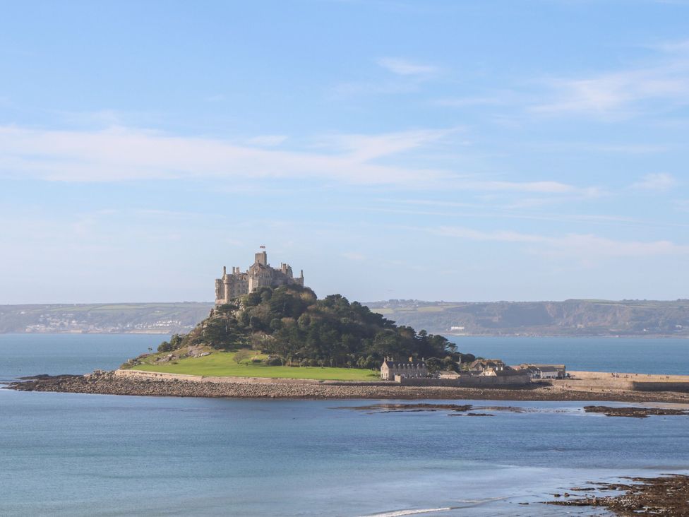 A castle on an island next to the ocean at 1 Rowes Cottages Penzance