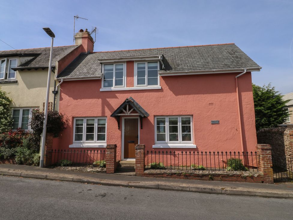A house with a pink exterior and windows at 13 School Road Newton Abbot
