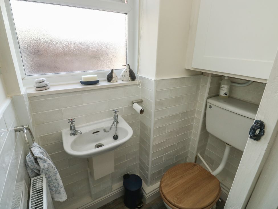 A bathroom with a basin and toilet at 13 School Road in Newton Abbot