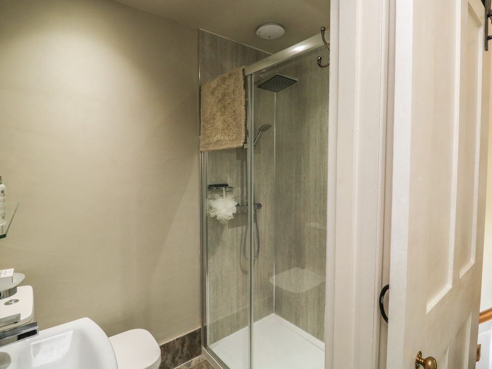 A bathroom with a shower and toilet at 13 School Road, Newton Abbot
