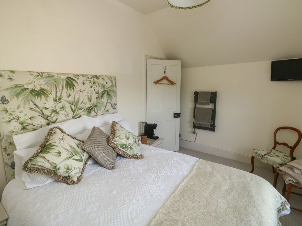 A bedroom with a bed and television at 13 School Road Newton Abbot