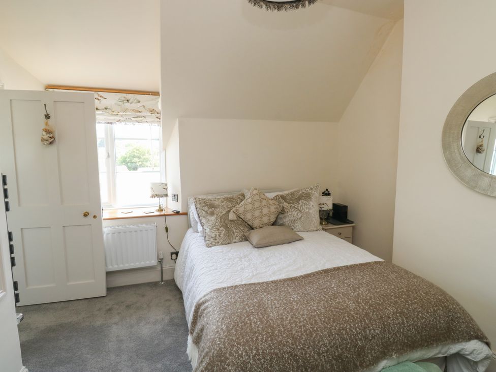 A bedroom with a bed and window at 13 School Road in Newton Abbot