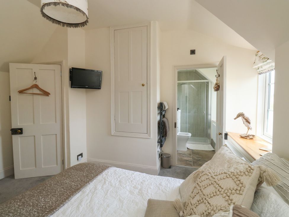 A bedroom with a bed and attached bathroom at 13 School Road in Newton Abbot